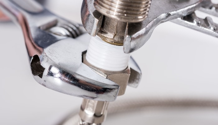 Closeup Plumber Screwing Plumbing Fittings